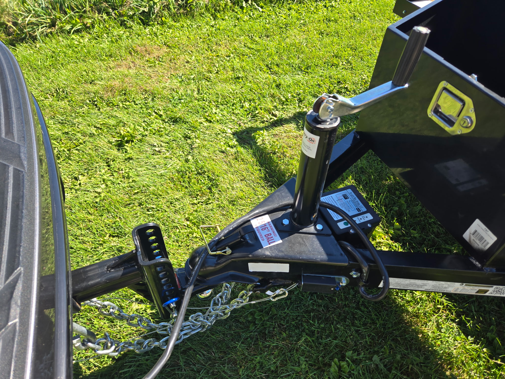Trailer coupler, crank jack, safety chains and breakaway box connected to an adjustable ball mount