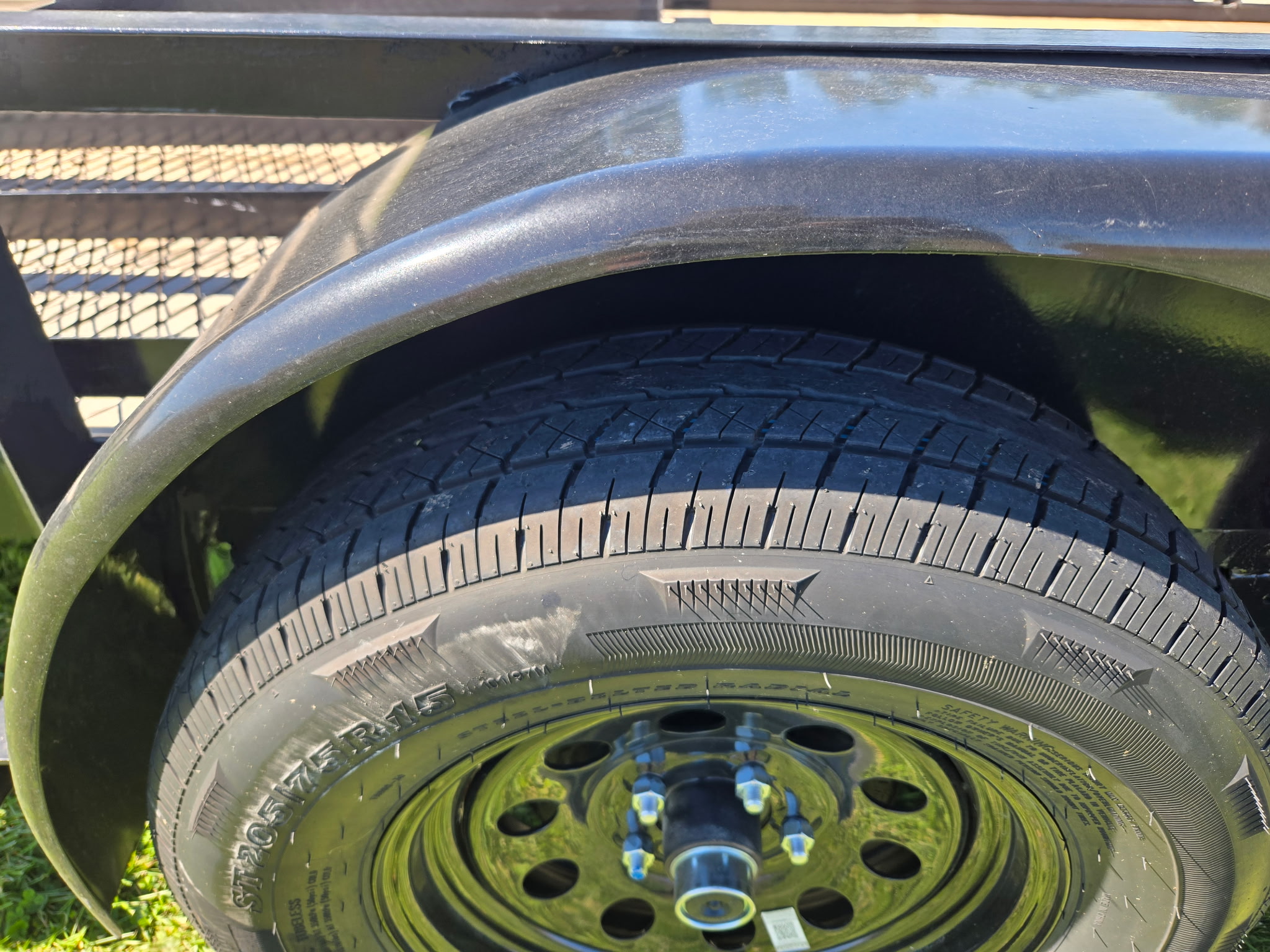 ST205/75R15 radial trailer tire and wheel under the fender